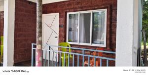 a house with a white door and a blue fence at Sai Holliday's home in Alibaug