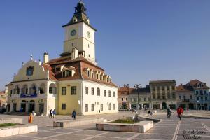 a building with a clock tower on top of it at BrasovApart Piata Sfatului in Braşov