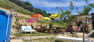 un groupe de parasols et de chaises dans une cour dans l'établissement Tenuta Ornella, à Miglianico
