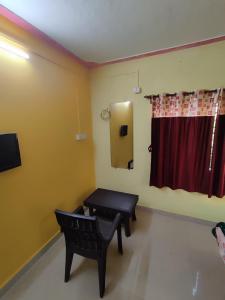 a waiting room with a bench and a red curtain at Shri Samarth Homestay in Diveagar
