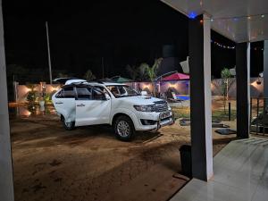 a white suv parked in a parking lot at night at sarahs apartments solwezi in Mpemba