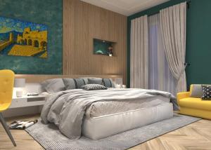 een slaapkamer met een bed en een gele stoel bij Residence Arechi in Salerno