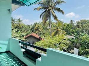a balcony with a view of the jungle at Akarsha Residence in Negombo