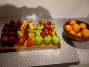 a tray of fruit on a counter with a bowl of fruit at Star Holiday in Virār +7 photos