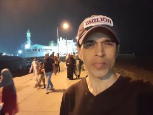 a young man wearing a hat in front of a group of people at Star Holiday in Virār