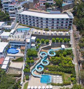 an aerial view of a resort with pools and slides at Alba Suites Acapulco in Acapulco