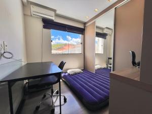 コンボリウーにあるCasa com Jacuzzi, Próximo Teleférico, GreenValley e Praia BC!の紫色のベッドが備わる部屋