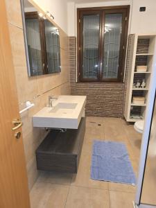 a bathroom with a sink and a mirror at Giulia's Penthouse in Cernusco sul Naviglio +37 photos