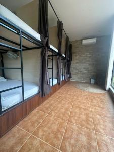 a room with three bunk beds and a tile floor at Jashill Homestay in Yên Minh
