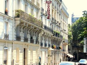 a building on a street with cars parked in front of it at Hôtel du Square d'Anvers in Paris