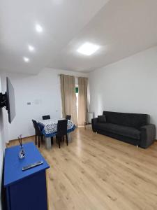 a living room with a couch and a table at Blu Oltremare in Nettuno