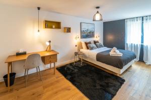 a bedroom with a bed and a desk and a desk at La Maison Bas Lachamp - Luxuary Mountain Villa in Bellefosse +46 photos