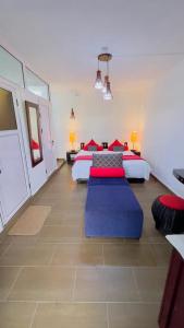 a bedroom with two beds with red and blue pillows at Ahavah Guesthouse in Trou dʼ Eau Douce