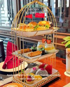 a display of food in a cage with plates of food at RiverTown Hoi An Resort & Spa in Hoi An