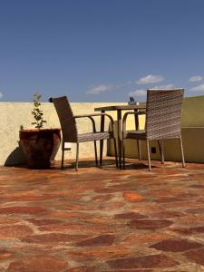 two chairs and a table on a patio at Namelok apartment in Sekenani