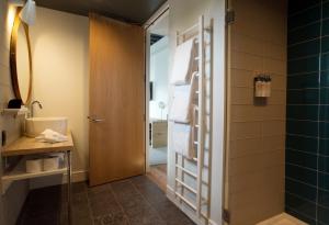 a bathroom with a shower and a glass door at 250 Main Hotel in Rockland