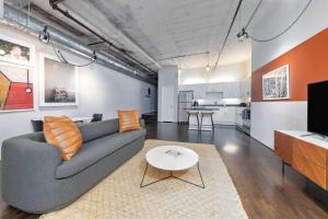 a living room with a couch and a table at Reside Houston Downtown, a Wyndham Residence in Houston