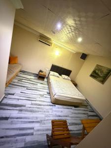 a room with a bed and a table and chairs at Evim Butik Otel in Seyhan