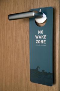 a sign on a door that reads no wake zone at 250 Main Hotel in Rockland