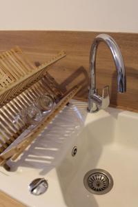 a sink with a faucet next to a kitchen counter at Escapade au Mont St Michel in Pleine-Fougères +10 photos