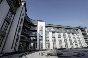 a large building with a fountain in front of it at Bogishamol Hotel in Andijan