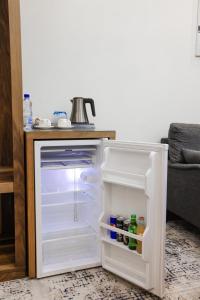 an empty refrigerator with its door open in a kitchen at Bogishamol Hotel in Andijan