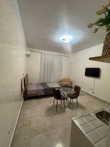 ブラザヴィルにあるEpayinayocgのベッドとテーブルと椅子のある部屋