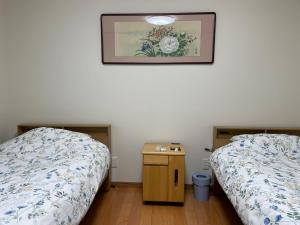 Postel nebo postele na pokoji v ubytování はなの環