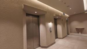 a hallway with a elevator in a building at Blanco Apartment Hotel in Bintulu