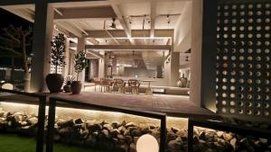 a house with a patio and a dining area at night at Blanco Apartment Hotel in Bintulu