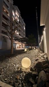 a white plate on the ground in front of a building at Blanco Apartment Hotel in Bintulu