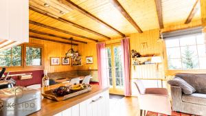 a kitchen with wooden walls and wooden ceilings at Chalet Dorle, Riederalp Golmenegg in Riederalp