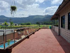 Un edificio con balcón con vista a las montañas. en Best and biggest place to have quality time, en Malavli