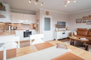 a living room and kitchen with a couch and a table at fien un moje in Borkum