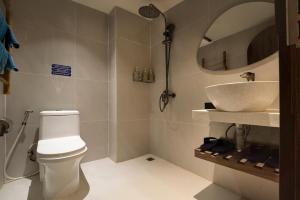 a bathroom with a toilet and a sink at Lune Boutique Apartment Da Nang in Da Nang
