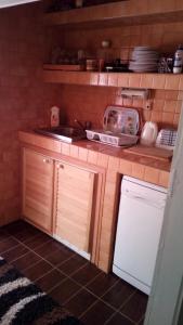 a small kitchen with a sink and a dishwasher at Judit nyaraló in Velence