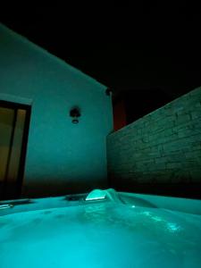 a bath tub in a room with a brick wall at La maison d'Alice - Calme - Climatisation - Parking privatif in Velaux