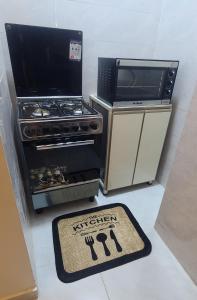 a kitchen with a stove and a rug on the floor at Luxor Sapphire in Luxor