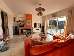 a living room with a couch and a table at Maison Margot Villa provençale a 300m de la plage in Cavalaire-sur-Mer