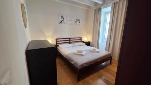 a bedroom with a bed with two towels on it at BG Time in Bergamo