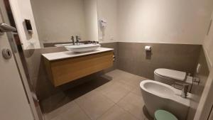 a bathroom with a sink and a toilet at BG Time in Bergamo