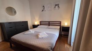 two beds in a bedroom with two towels on them at BG Time in Bergamo +7 photos