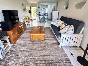 a living room with a couch and a coffee table at No. 1 Arrowood, Plettenberg Bay in Plettenberg Bay +6 photos