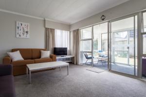 a living room with a couch and a table at Sea Breeze On Belt - near beach & coastal walk in New Plymouth