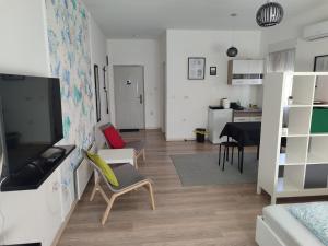 a living room with a couch and a dining room at Apartman Centar Surcin in Surčin