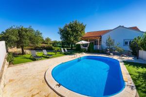 a swimming pool in the backyard of a house at My Dalmatia - Holiday home Emily with private pool in Raštević