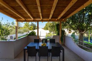 an outdoor dining area with a table and chairs at My Dalmatia - Holiday home Emily with private pool in Raštević +35 photos