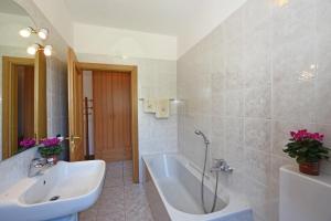 a bathroom with a tub and a sink at Viola in Colico +34 photos