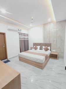 a bedroom with a bed with pillows on it at Hotel Pilgrim walking distance From Golden Temple in Amritsar