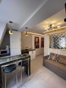 a kitchen and living room with a table and a couch at Central Park Rentals in Chişinău